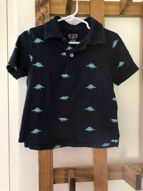 2A | Remera azul con cuellito y dinos. The Childrens Place. Talle 2 años.