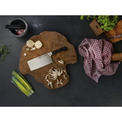 cutelo ZWILLING com cabo de sintético preto em cima de uma tábua de madeira