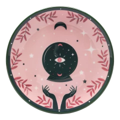 prato com borda em preto e interior rosa com desenhos de galhos, lua e bola de cristal 