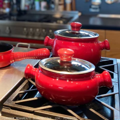 caçarolas de cerâmica em cima de um fogão e bancada