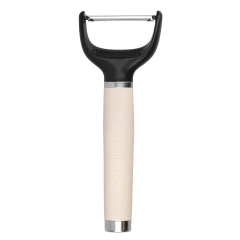 Descascador de legumes e frutas KitchenAid com cabo creme e lâmina de aço inox.
