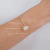 Bracelete Com Aros e Gota Cravejada Folheado a Ouro 18k