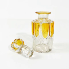Conjunto vintage de três perfumeiros de cristal com detalhes em amarelo, em diferentes tamanhos
