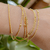 Pulseira Corda de Violão com Esferas/Bolinhas Soldadas 07 Voltas no Braço Banho de Ouro 18k
