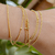 Pulseira Corda de Violão com Esferas/Bolinhas Soldadas 07 Voltas no Braço Banho de Ouro 18k