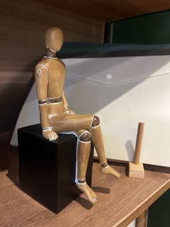 Escultura Boneco perna direita cruzada na internet