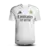 Camisa branca do Real Madrid I 2024/25 com o nome Vini Jr. e número 7, modelo torcedor masculino.