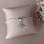 Pulseira cordão baiano com olho grego strass - Peregrinas