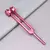 Diapasão rosa com frequência de 256 Hz, posicionado sobre uma superfície cinza.