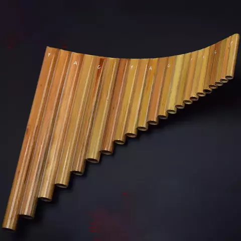 Flauta Pan de Bambu com 22 tubos dispostos em formato curvo, destacando a textura natural da madeira.