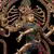 Estátua detalhada de Shiva Nataraja, representando o deus dançante em uma pose dinâmica, decorada com pedras coloridas.