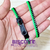 Foto: Pulseira zíper de plástico com uma faixa verde e outra preta.