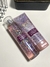 Conjunto de produtos Bath & Body Works A Thousand Wishes, incluindo um creme hidratante e um body splash, ambos com embalagem decorativa e cores em tons de rosa.