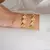 BRACELETE RÍGIDO TREVOS DETALHADOS DOURADO FOLHEADO na internet