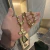 Imagem do CORRENTE CHAPAS TRANÇADAS FECHO CANHÃO (10MM) - 60 OU 70CM + PINGENTE CRUZ DESIGN FLOR DE LOTUS 3D 6CM (6X3CM) - PRATA COM OURO 18K