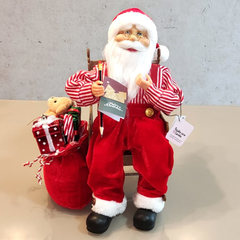 Papai Noel de 40cm sentado na cadeira de balanço movimento e som - 51837001