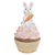Cupcake decorado com um coelhinho da Páscoa segurando uma cenoura, com cobertura rosa e confeitos coloridos.