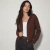 Campera mujer tejida trenzada con capucha y cierre
