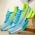 Tênis de corrida esportivos em cores azul e verde neon, com design moderno e solado acolchoado.