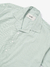 Camisa boxy listrada verde água com colarinho, botões brancos e etiqueta KMZ.
