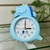 Reloj despertador dinosaurio / celeste