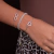 Pulseira Ajustavel com Pingente Infinito com zirconias banhada em rodio branco - comprar online
