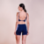 Top Betina feminino de treino, disponível nas cores marrom ferrugem, azul e preto. Tecido anticelulite com alças finas e recorte nas costas.