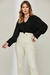 Modelo vestindo blusa feminina Versalhes preta com calça clara