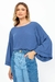 Mulher vestindo CALÇA JEANS MIX com blusa azul de mangas largas