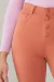foto frontal da Calça andréa botões skinny terracota, com foco nos detalhes dos botões, cós com passantes e fivepockets