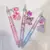 Caneta Com Pingente Sanrio Flowers - Papelaria Mundo Kawaii
