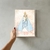 Quadro representando Nossa Senhora de Nazaré segurando o Menino Jesus, com um fundo floral suave.