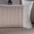 Peseira de cama em tom bege com almofadas brancas, parte do Kit Peseira Copacabana 5 Peças Queen.