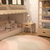 Tapete redondo abstrato nas cores rosa e bege em um quarto infantil, com móveis de madeira e decoração suave.