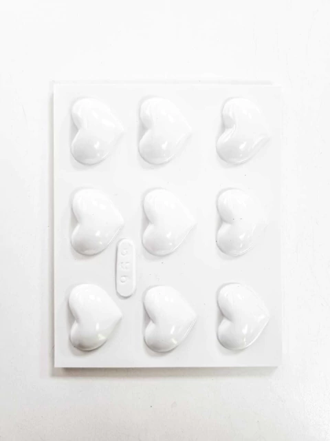 Molde de silicona en forma de corazones, con espacio para hacer nueve bombones.