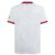Camisa branca do AC Milan com detalhes em vermelho e preto, exibindo logo da equipe e patrocinadores.