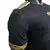 Camisa preta da Seleção do México, modelo 25/26, com detalhes em amarelo e design moderno e estilizado.