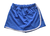 Shorts saia juvenil azul com faixa branca, ideal para uniforme escolar de 10 a 14 anos.