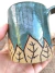 Caneca de cerâmica artesanal com design de folhas, capacidade de 250ml. 