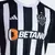 Camisa masculina do Atlético Mineiro, modelo 24/25, nas cores preto e branco, com detalhes da marca Adidas e logotipo do patrocinador Betano.
