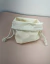 Saquinho de algodão cru personalizado com o nome "Charlotte" bordado, com cordão para fechar.