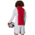 Back view of a man wearing an Ajax 125th anniversary Adidas long sleeve jersey in red and white, holding a soccer ball.
