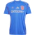 Camisa azul feminina da Universidad Chile Home 2025, com detalhes em vermelho e logotipos da Adidas e Juga Bet.