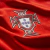 Close-up of the Portugal national football team's crest on a red jersey, showcasing intricate design details.