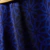 Close-up of a blue fabric featuring an intricate pattern, designed for the St. Patrick Days 2025 Jersey by Umbro.