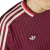 Bayern Munchen 2025 Adidas red jersey featuring horizontal stripes and the iconic Adidas logo.
