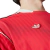 Close-up of the Adidas logo on the Manchester United 2025 red jersey.