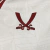 Close-up of the Sheffield United Third 2024/2025 jersey featuring a beige background with red embroidered logo and design elements.