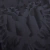 Close-up of the black Albânia Third 2023/2024 jersey featuring a textured pattern.