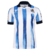 Camisa Real Sociedad Home 2023/2024 Branca e Azul Macron Torcedor Masculina